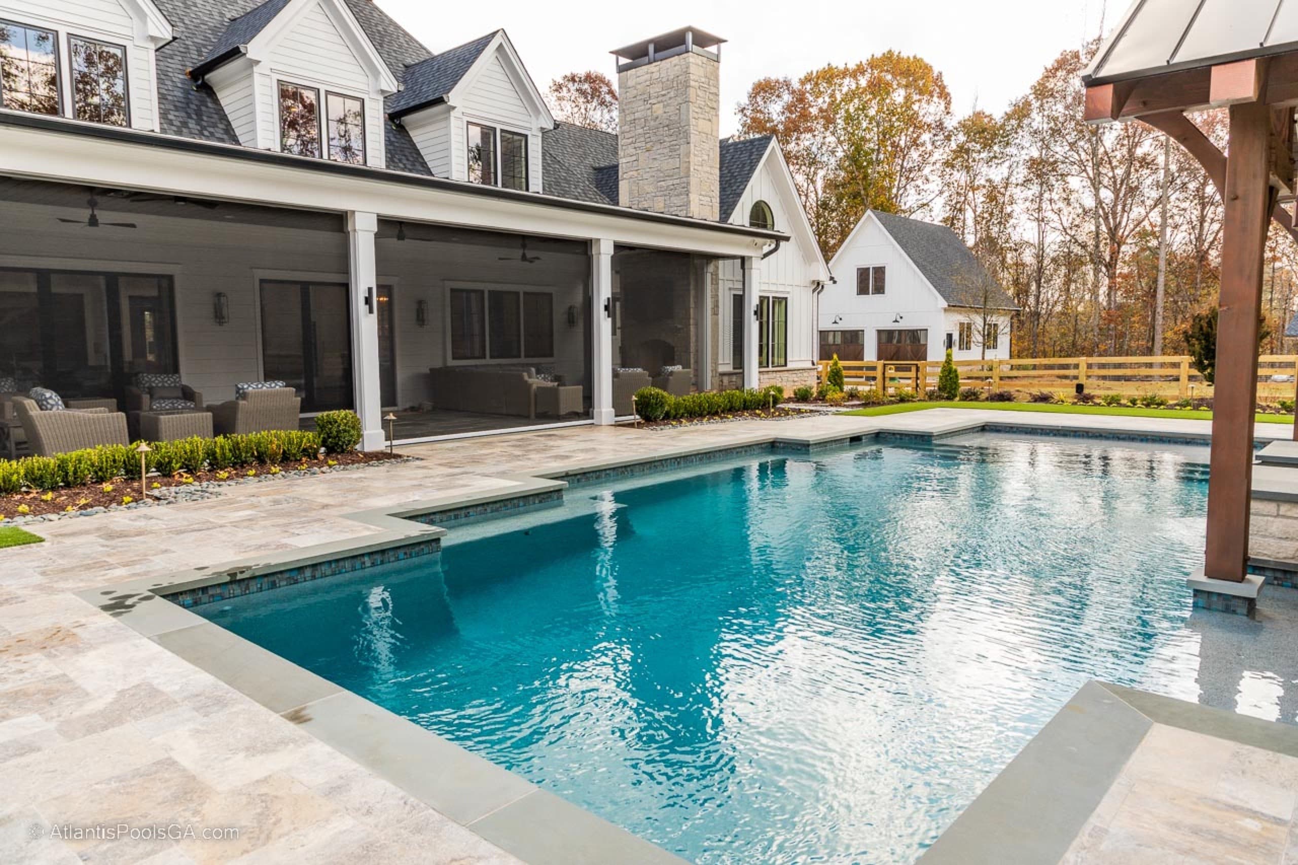 The Bolduc linear pool and tanning shelf beside a modern farmhouse estate