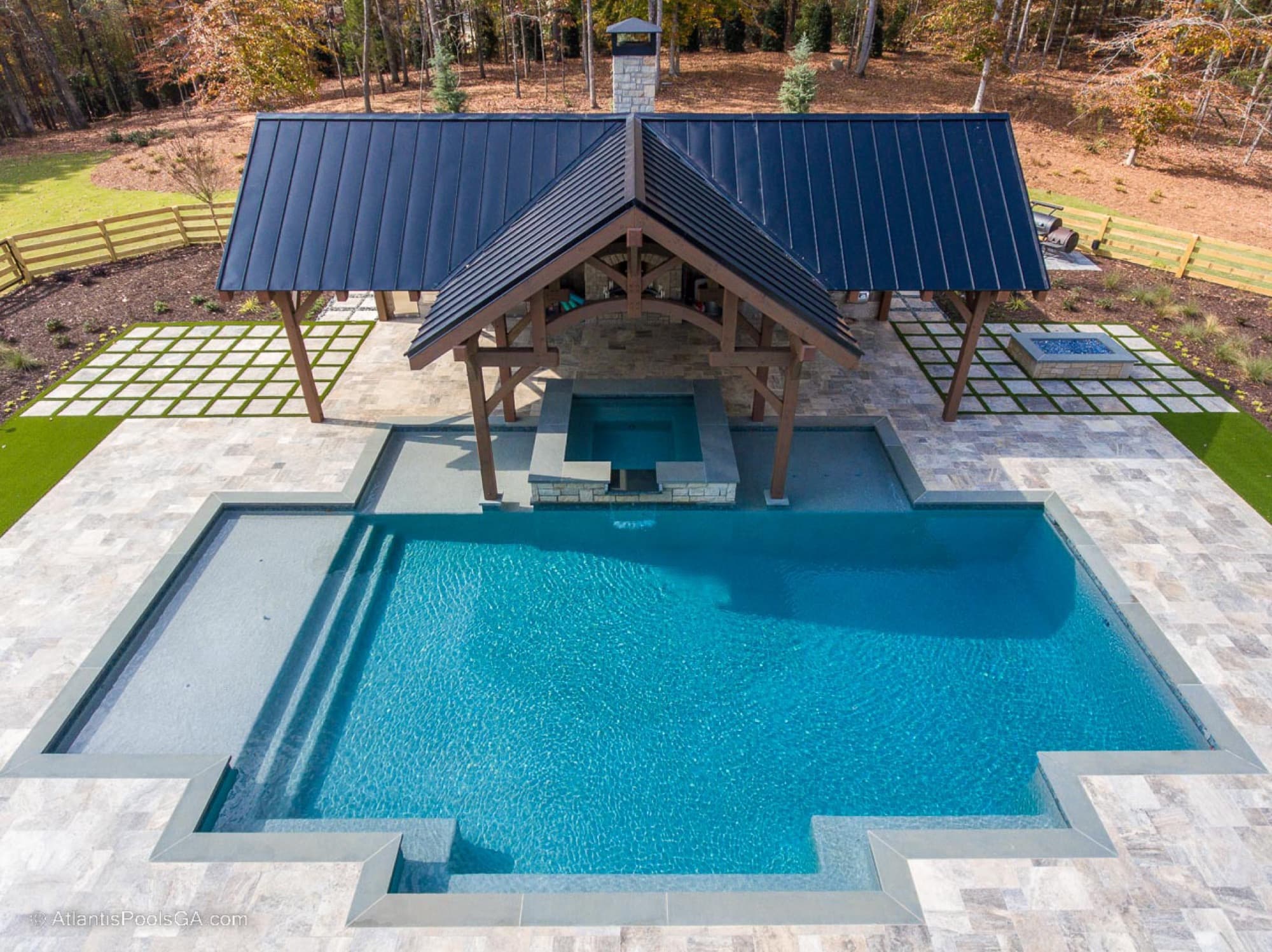 Aerial view of the Bolduc pool, covered pavilion, outdoor kitchen, raised spa, and tanning shelf