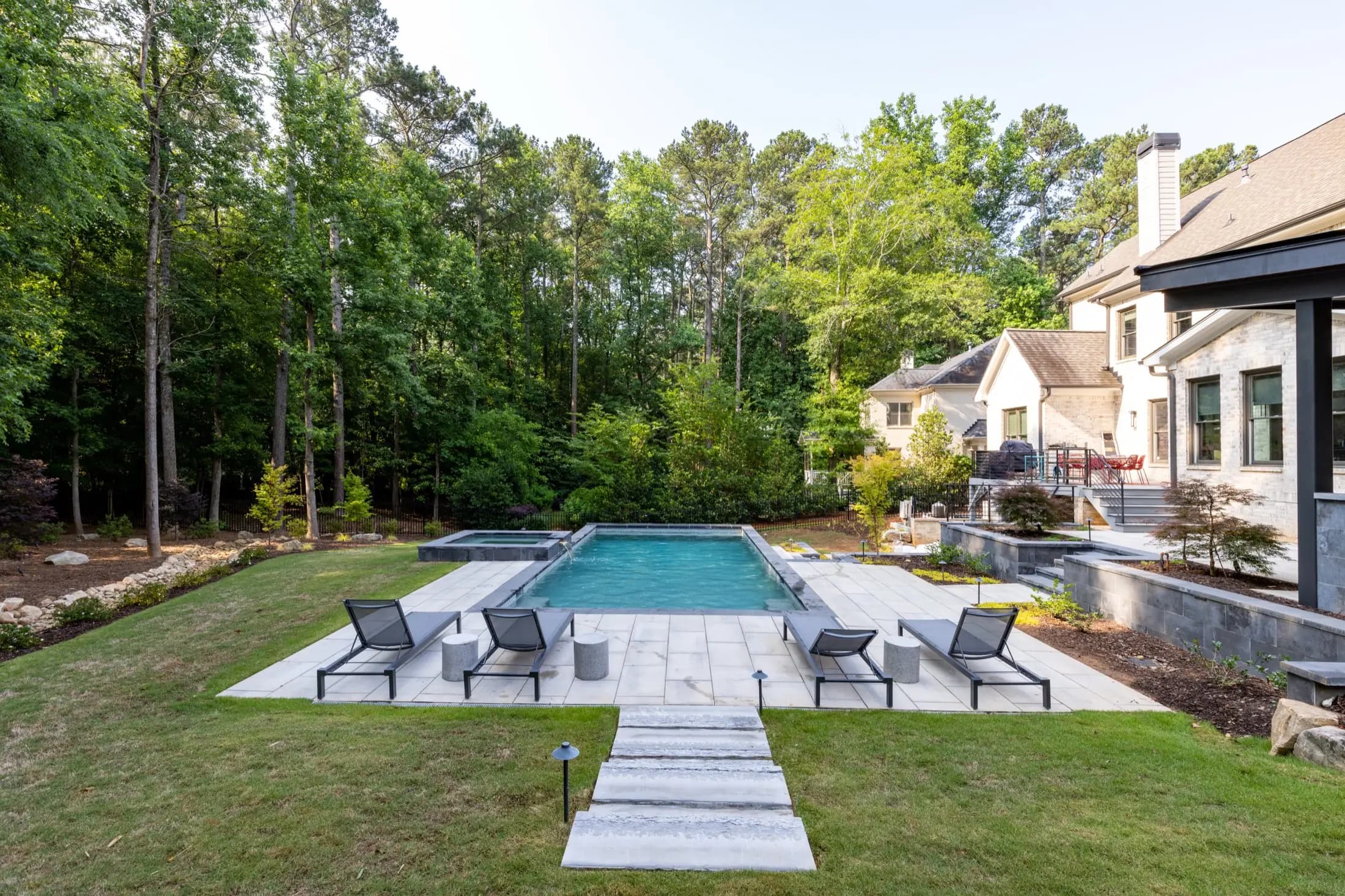 Linear pool with dark loungers and stepping pads at the Lipson project in Atlanta
